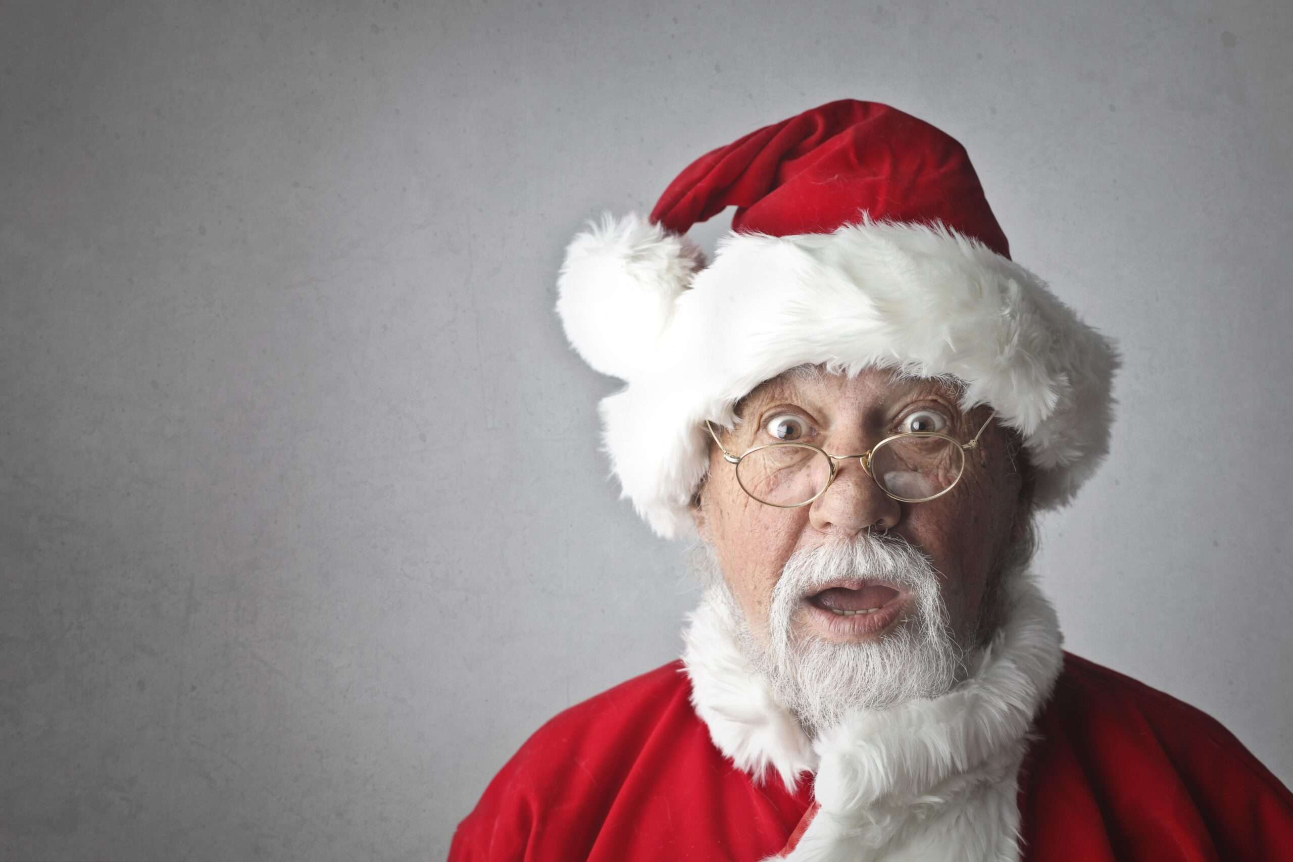 Man dressed as Santa Claus in a red suit with white beard