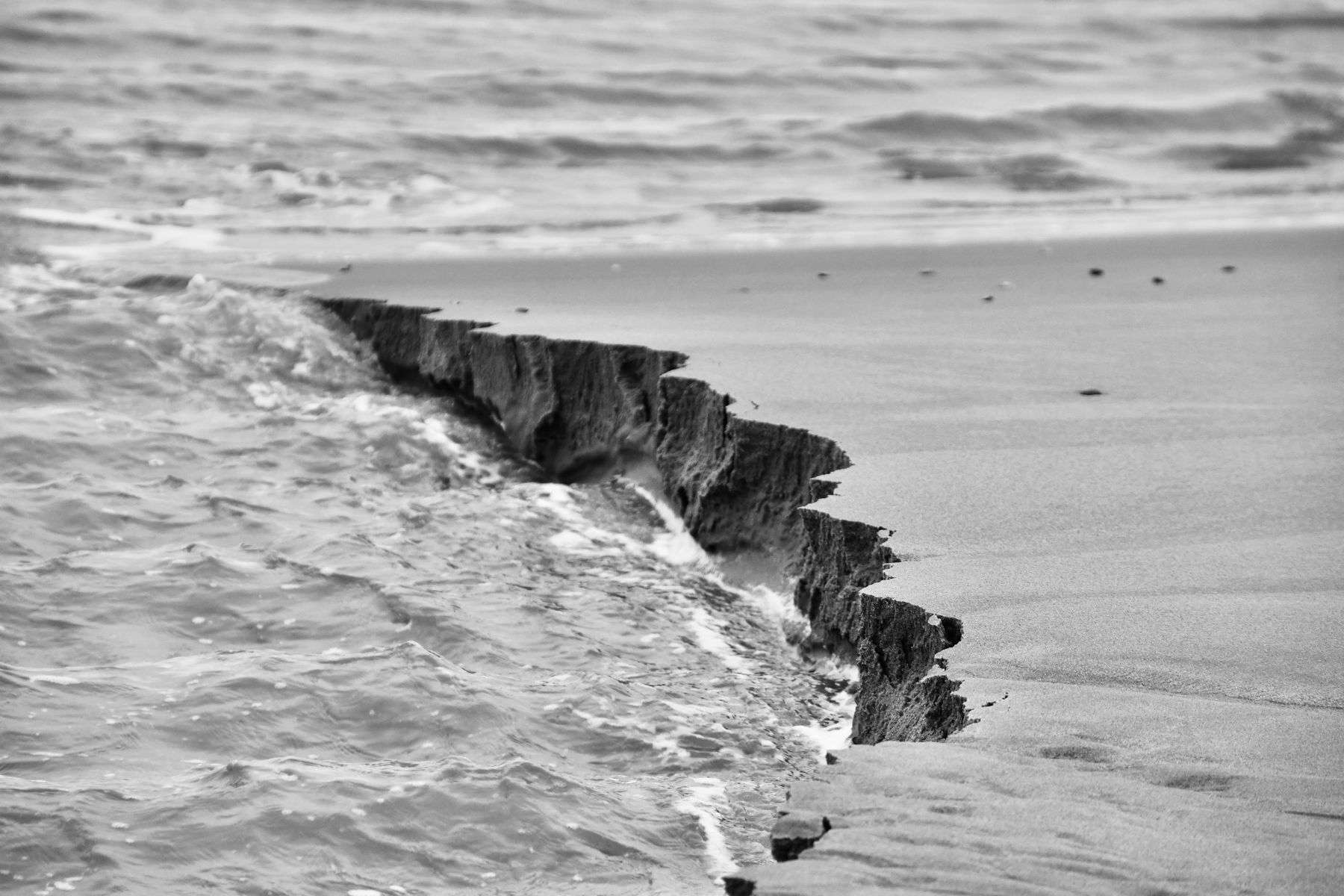 Waves washing against an eroding sandy shoreline on a barrier island
