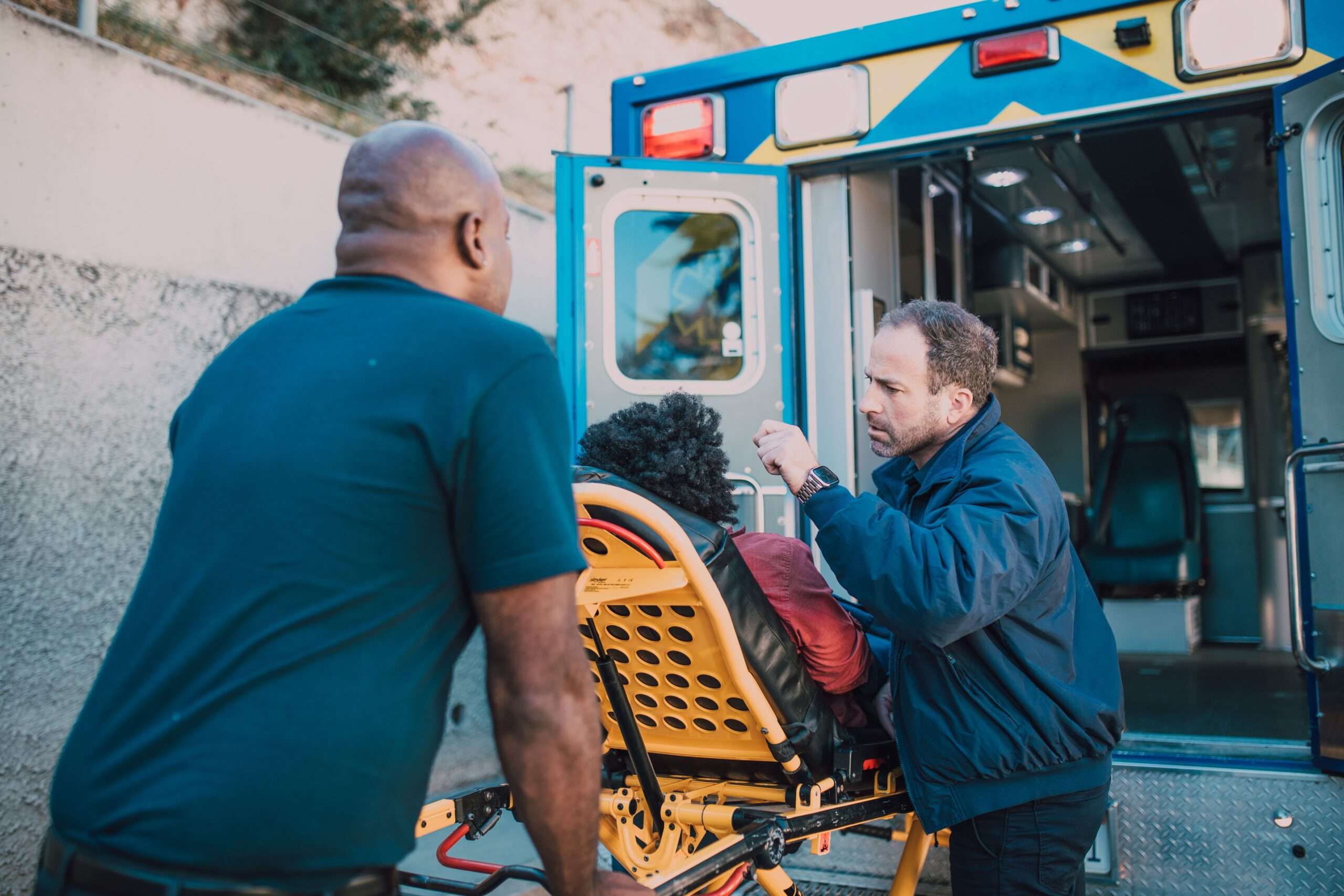 Medical personnel in uniform providing hands-on emergency care to a patient
