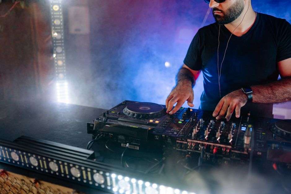 DJ mixing music on turntables during a hip-hop event
