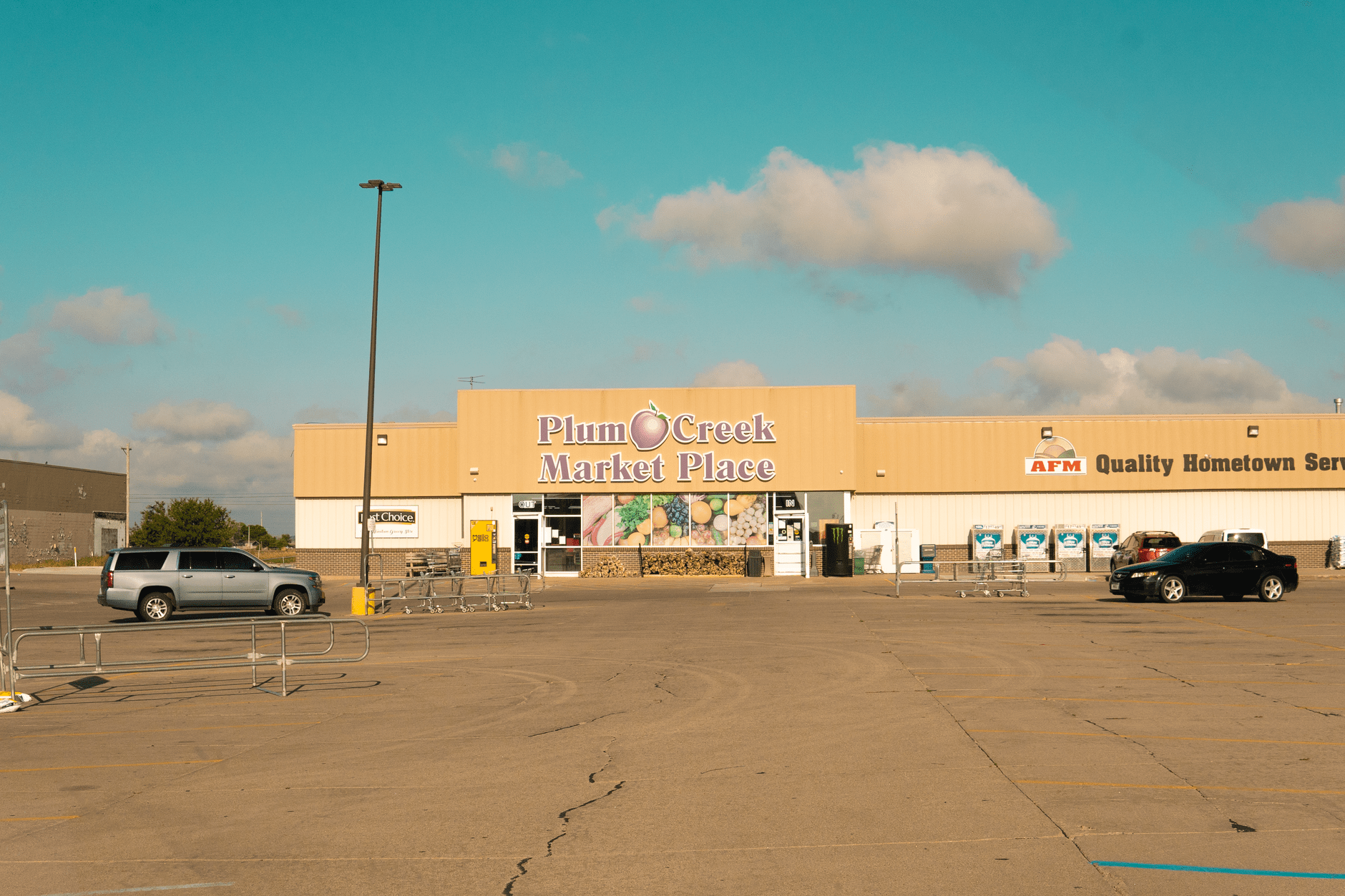 Exterior of a grocery store storefront and parking lot
