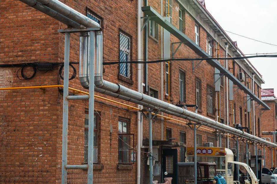 Construction crew installing utility pipe on a downtown street