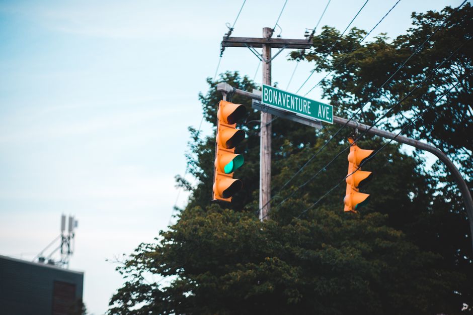 A traffic light at a busy intersection with cars waiting