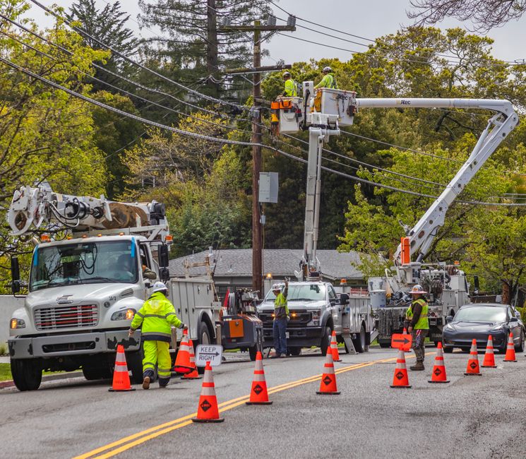 Power lines and utility equipment against a cloudy sky
