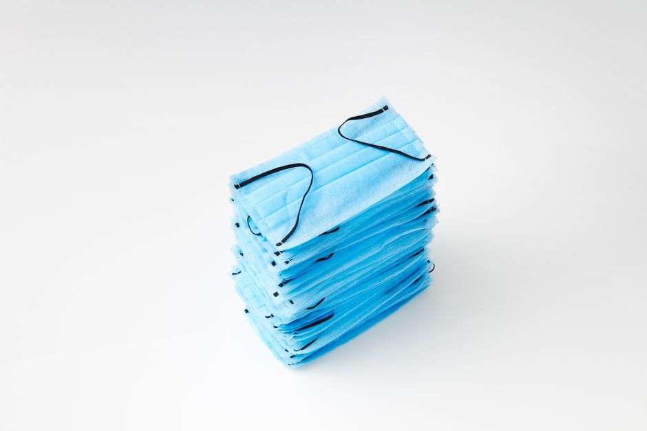 A stack of blue surgical face masks similar to those donated to protect first responders and health care workers