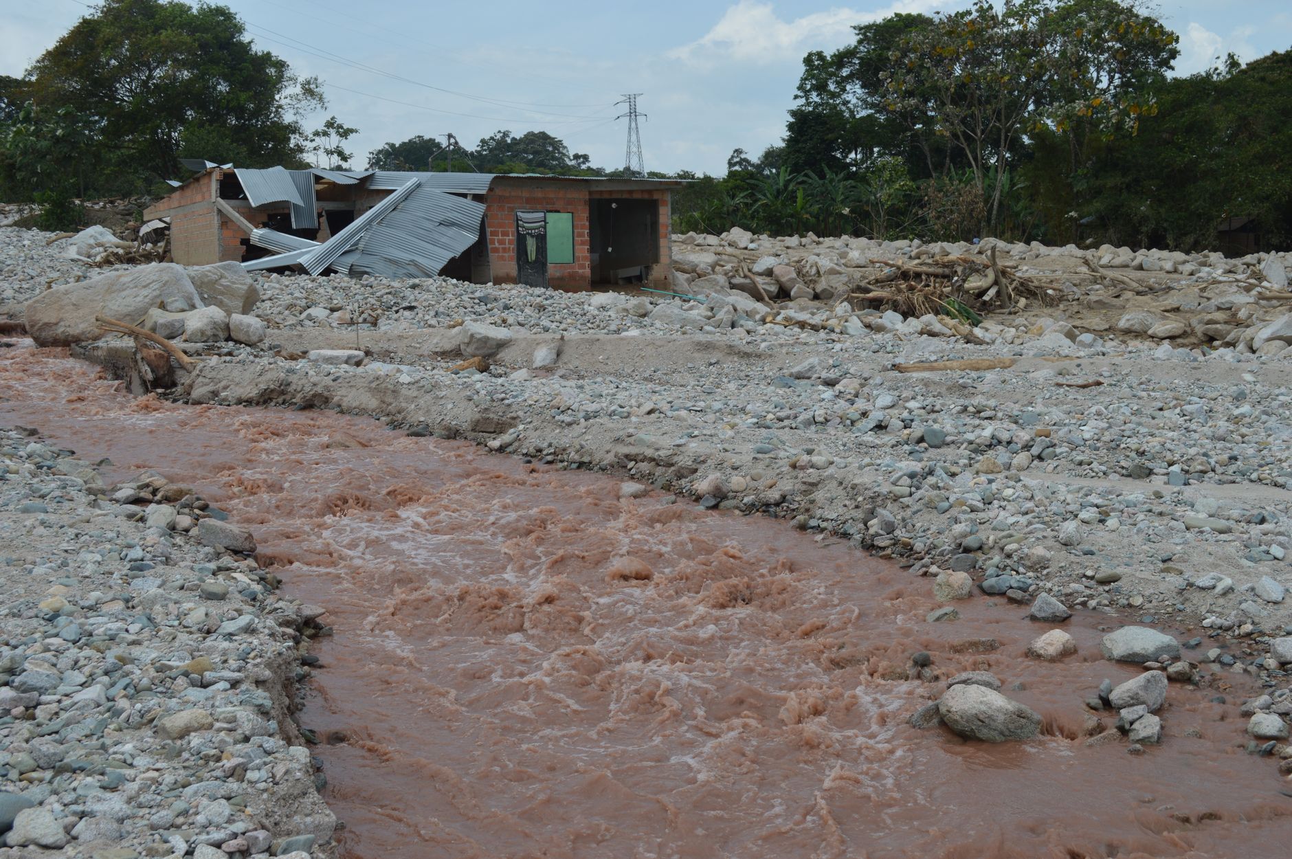Road and embankment damaged by heavy flooding and erosion
