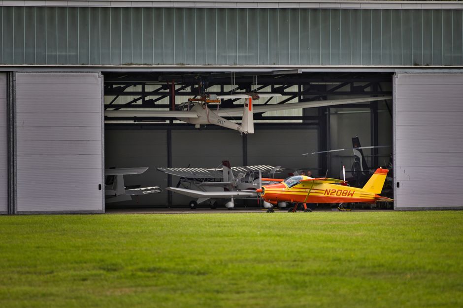 An aviation training academy building near an airport hangar