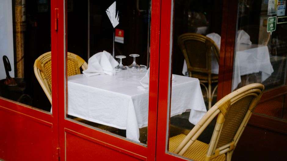 A cozy table set with glassware at a small bistro-style restaurant