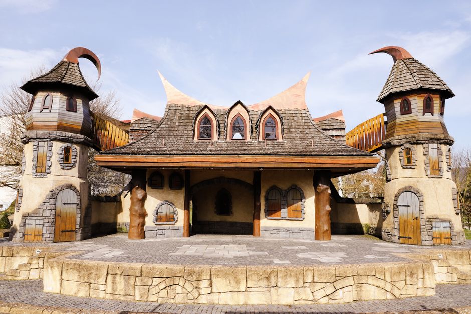 Handbuilt storybook castle home in Fairhope, Alabama with turrets and a bridge