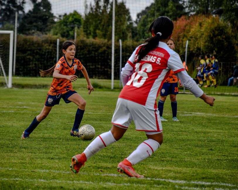 High school girls soccer player controlling the ball during a match