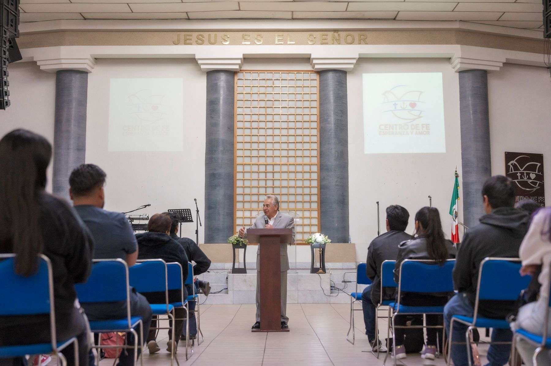 A speaker addresses an attentive audience during a faith-based youth gathering