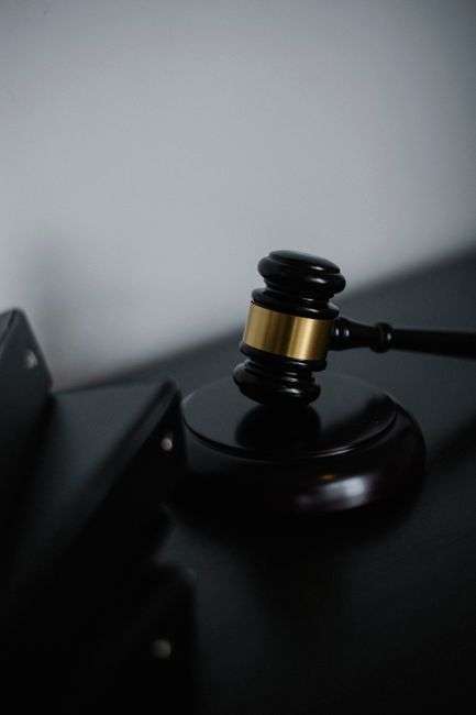 A judge's gavel resting on a desk in a courtroom