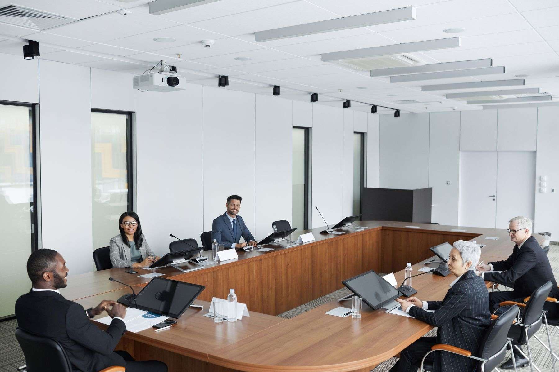 Board members and staff seated around a conference table during a meeting