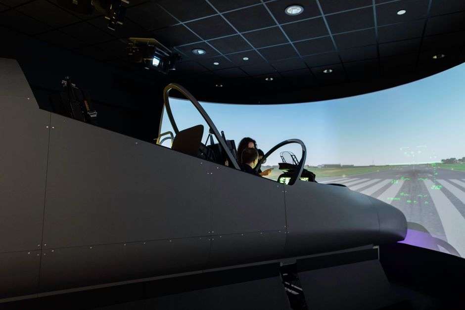 A visitor uses a flight simulator at an interactive aerospace education center