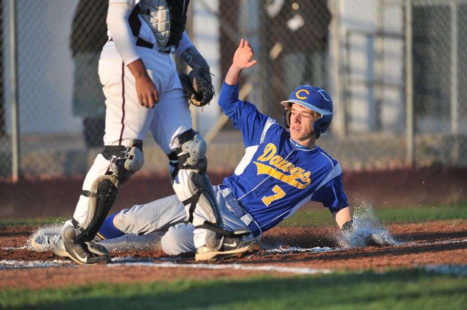 High school baseball first baseman fielding during a game