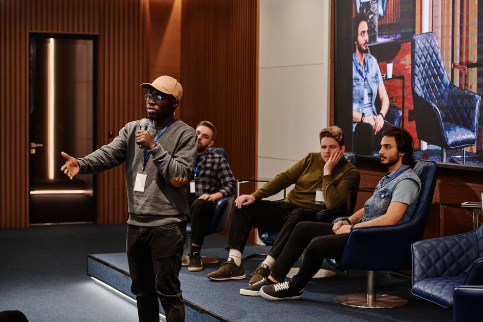 A panel discussion in front of a seated audience
