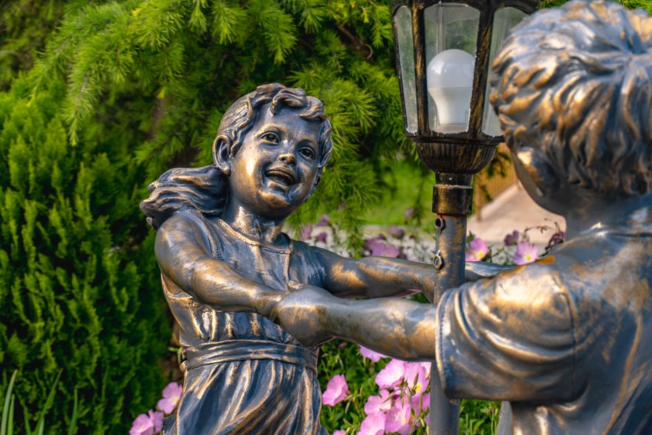 A bronze statue installed in a small city park, similar to Foley's new public art piece