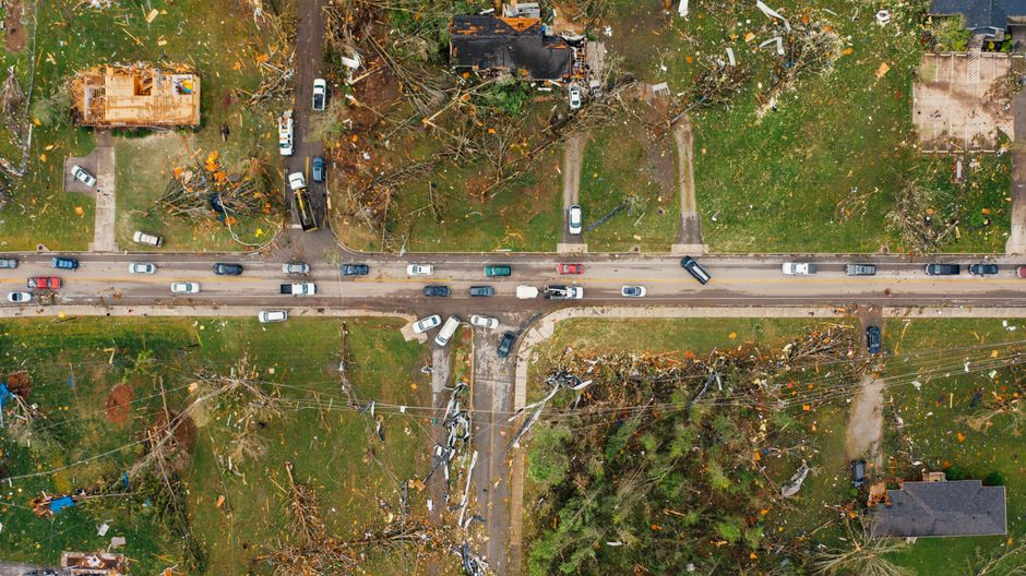 High winds from a storm causing debris hazards on a roadway
