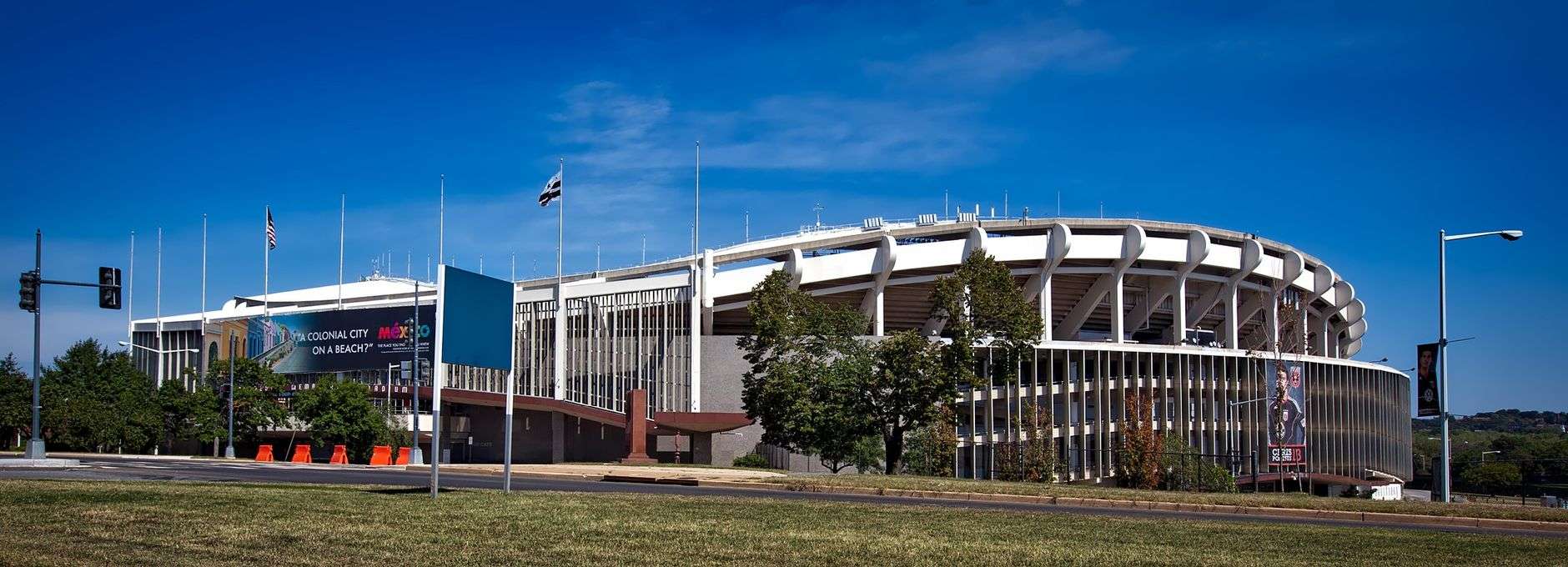 Exterior view of a large outdoor football stadium under a clear sky