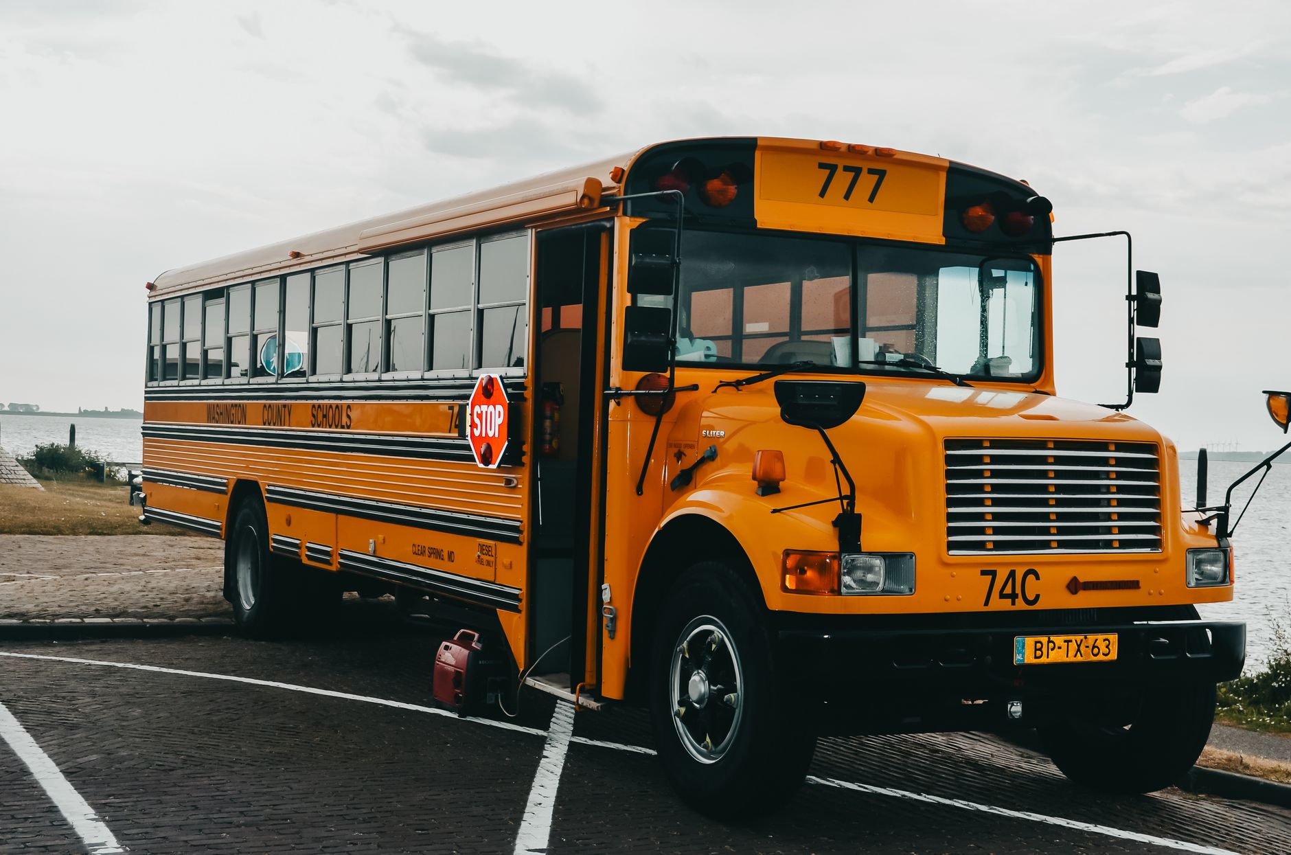 Yellow school buses parked outside a public school