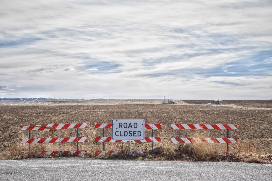 Closed rural road with construction equipment for drainage repair