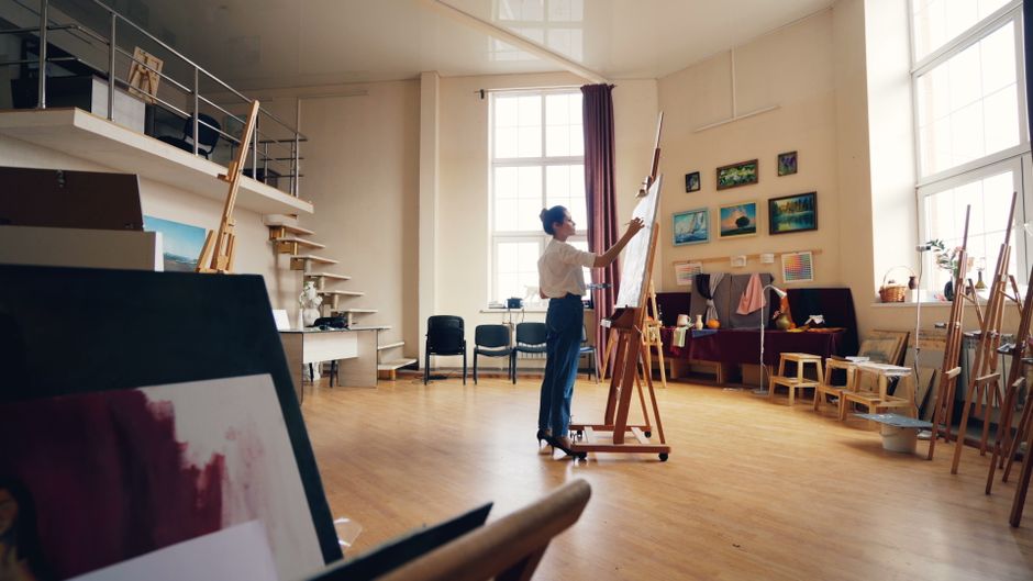 An art gallery studio space with paintings on display