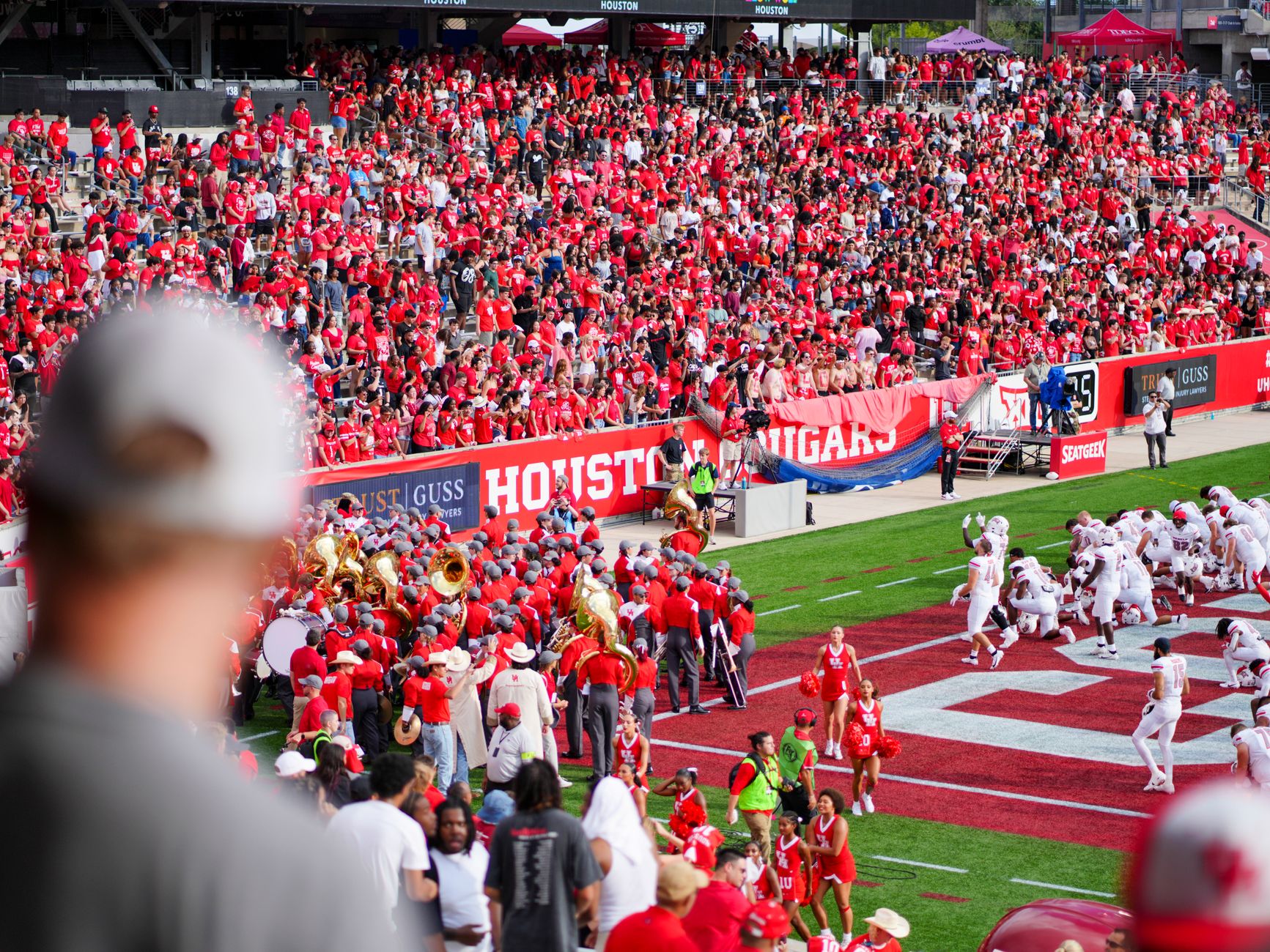 Spectators filling the stands at a college football game