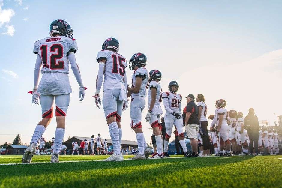 High school football players lined up on the field before a game