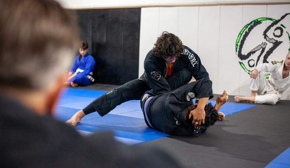 Students training in a jiu-jitsu martial arts dojo