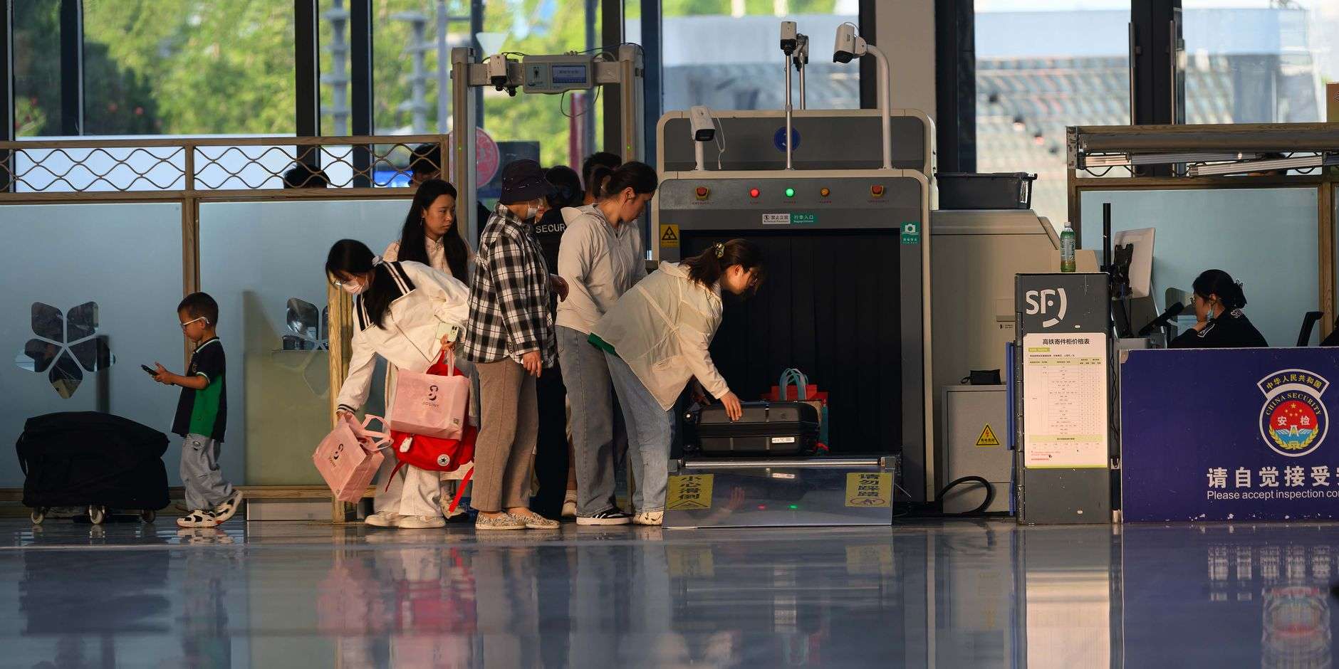 Travelers passing through an airport security screening checkpoint