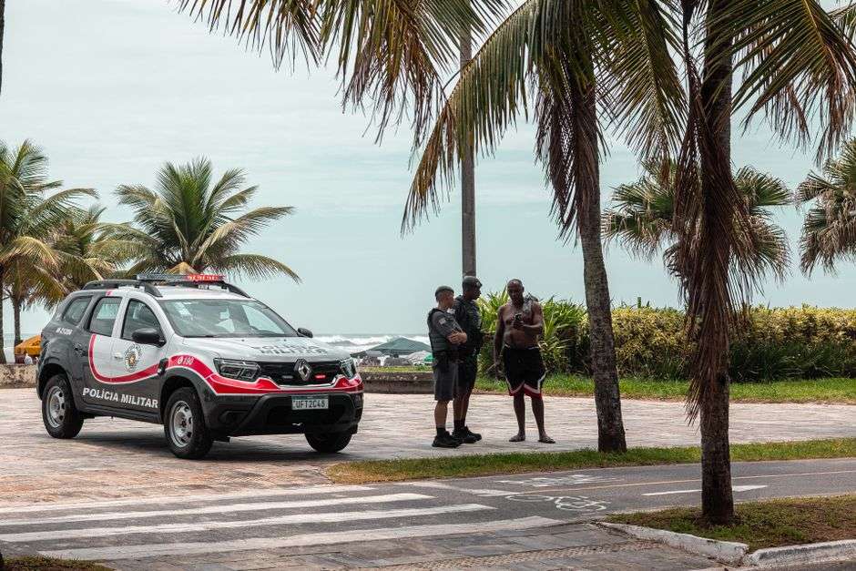 Police vehicle patrols near a public beach access area during spring break