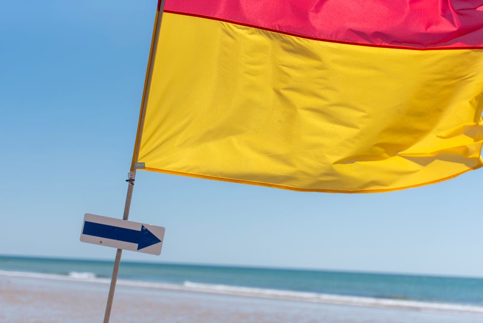 Warning flag on a Gulf Coast public beach signaling rough surf conditions