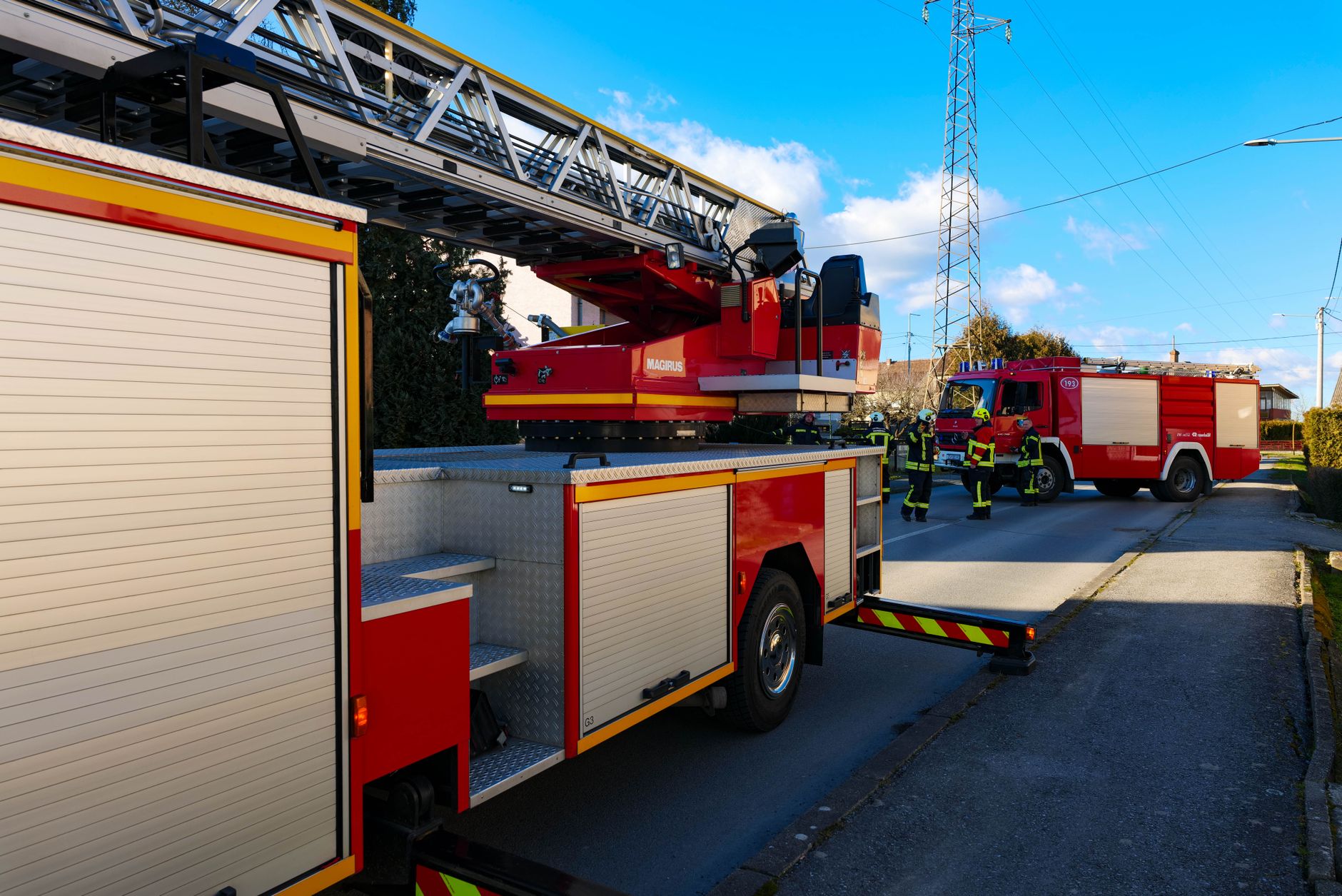 Firefighters posing in front of a fire engine