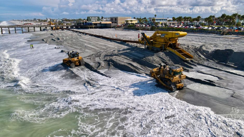 Dredging and bridge construction equipment at a coastal pass