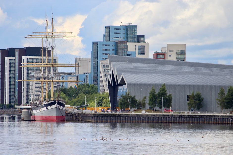 A modern maritime museum building along a downtown riverfront