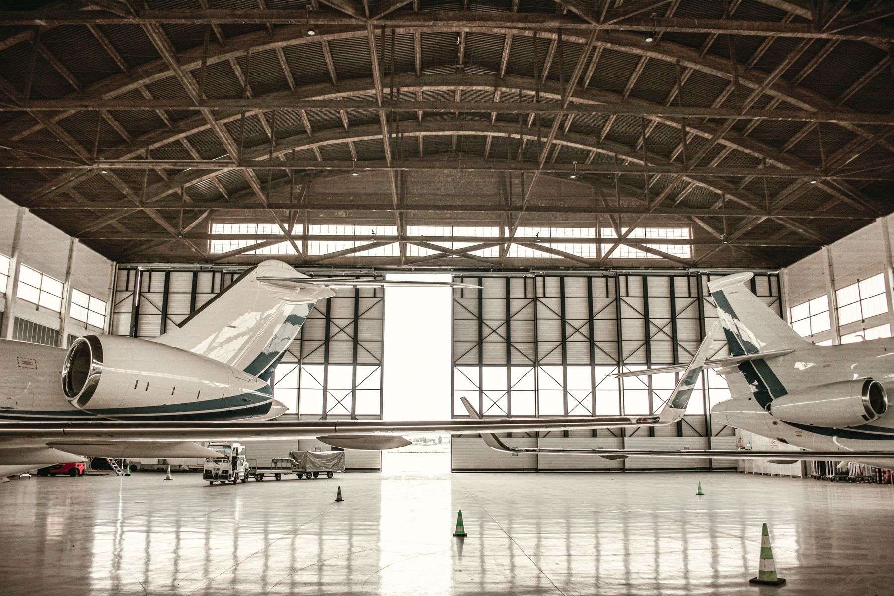 Airplanes parked inside a large aircraft assembly hangar