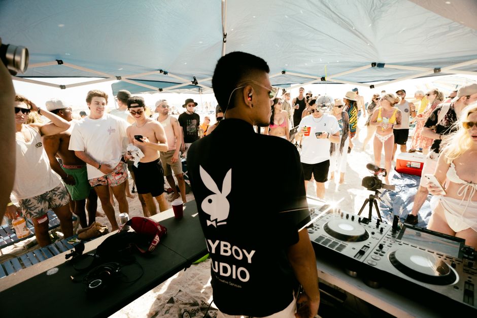 Large crowd gathered at an outdoor beach music festival