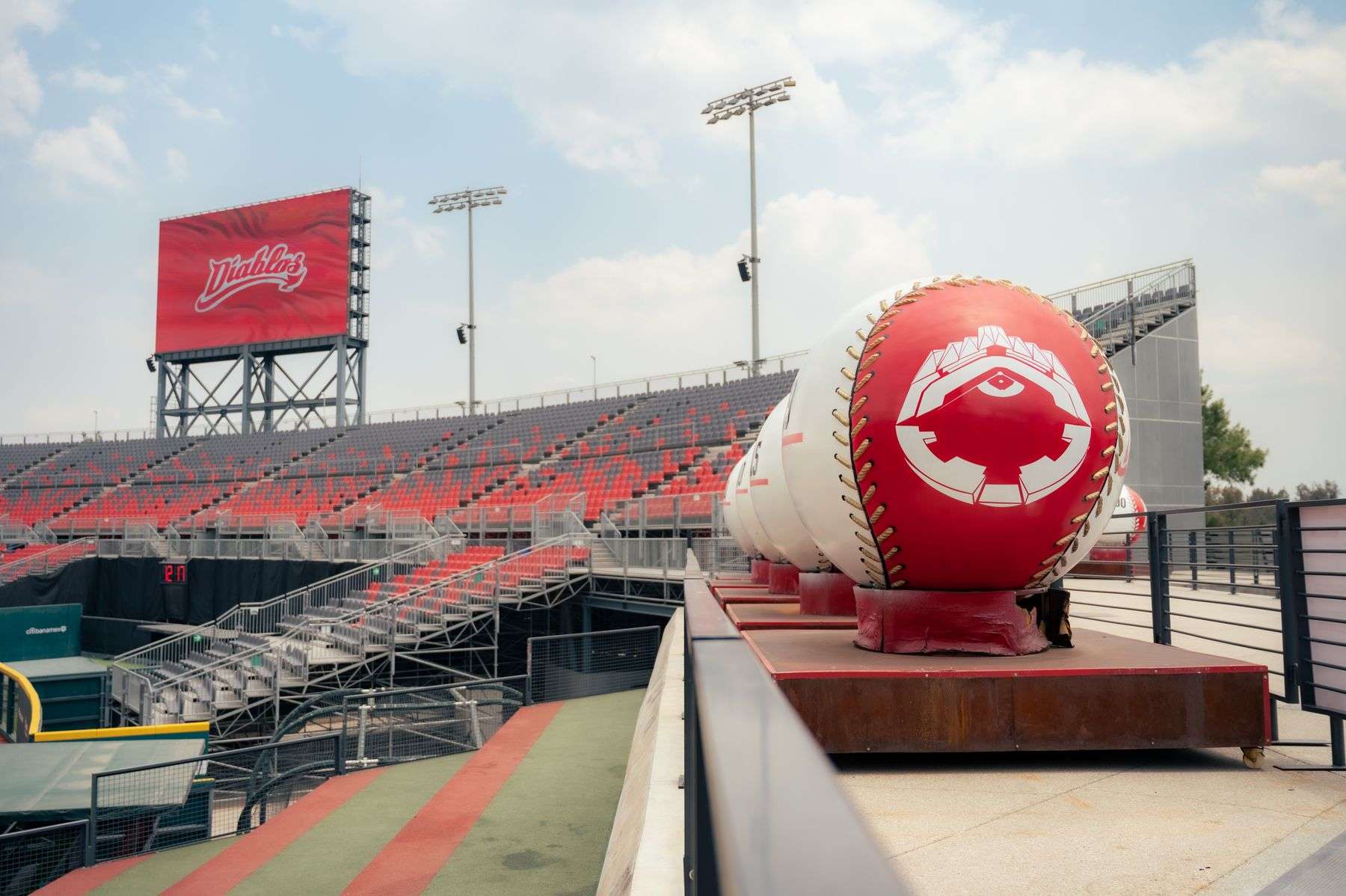 Rows of empty stadium seats overlooking a baseball field