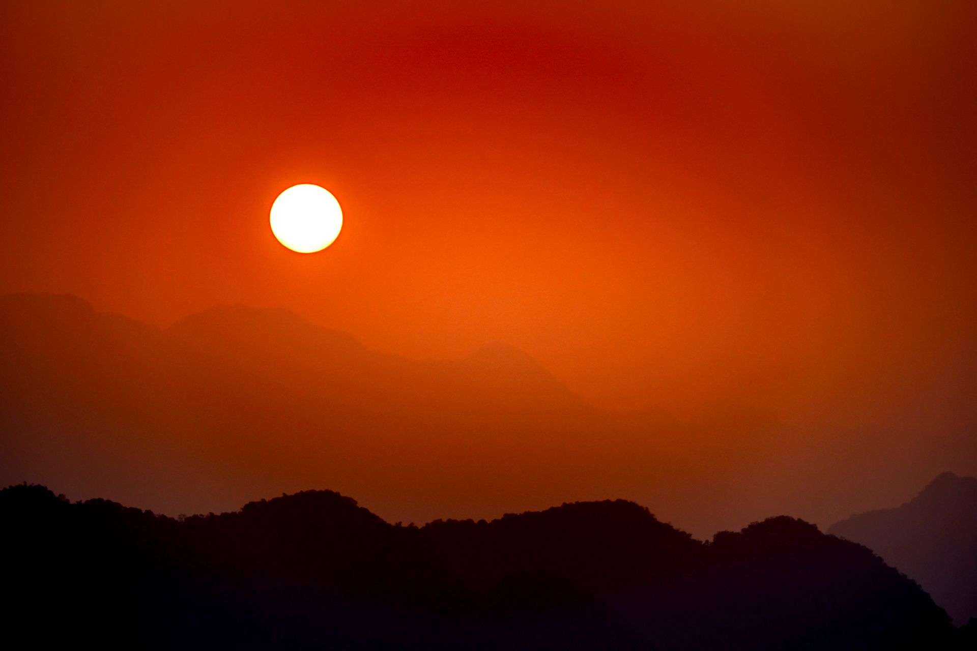 Bright sun in a clear, hot sky over South Alabama during an extreme heat warning