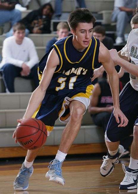 High school basketball players competing during a game