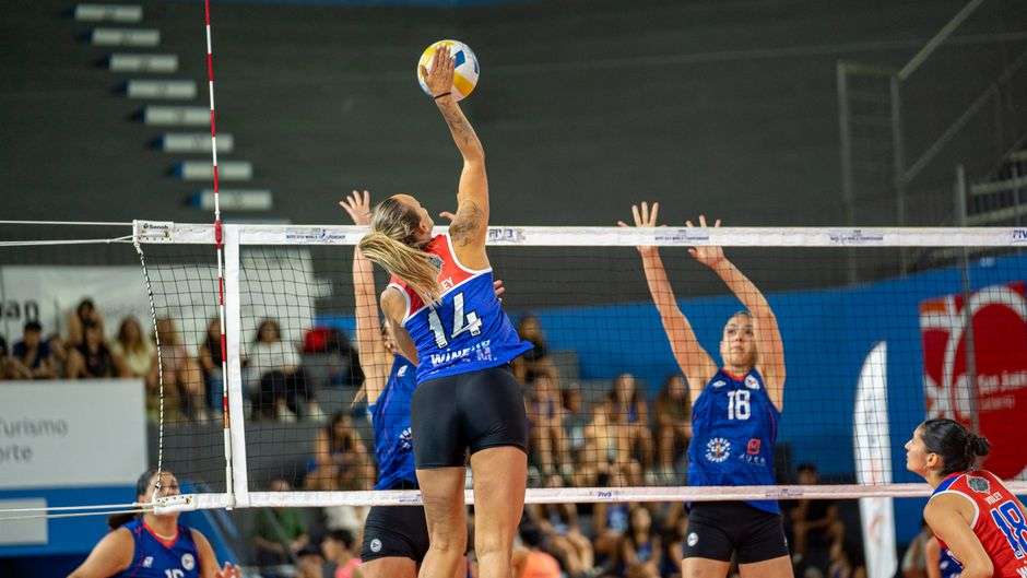 High school volleyball players compete during a match as the postseason tournament season begins