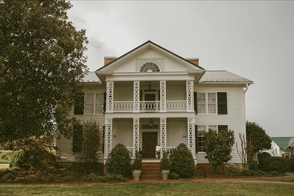 Historic bed and breakfast style home with a wraparound porch in a Mobile neighborhood