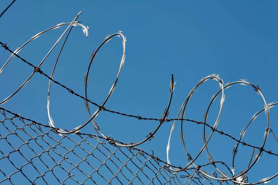 Razor wire tops a security fence at a state correctional facility