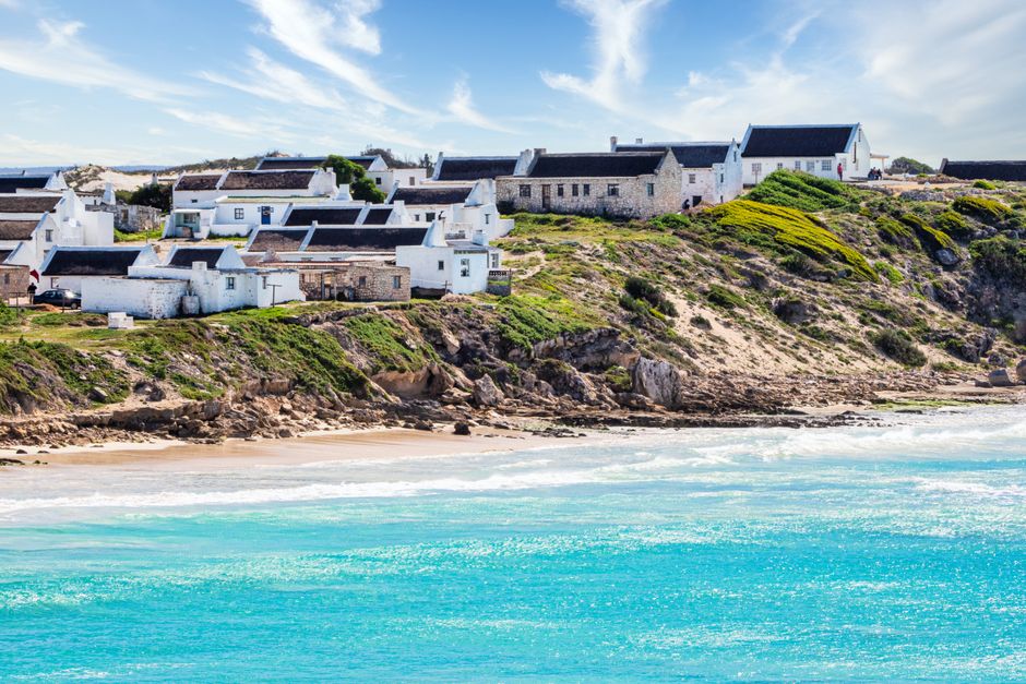 Old beach cottages along a sandy coastline