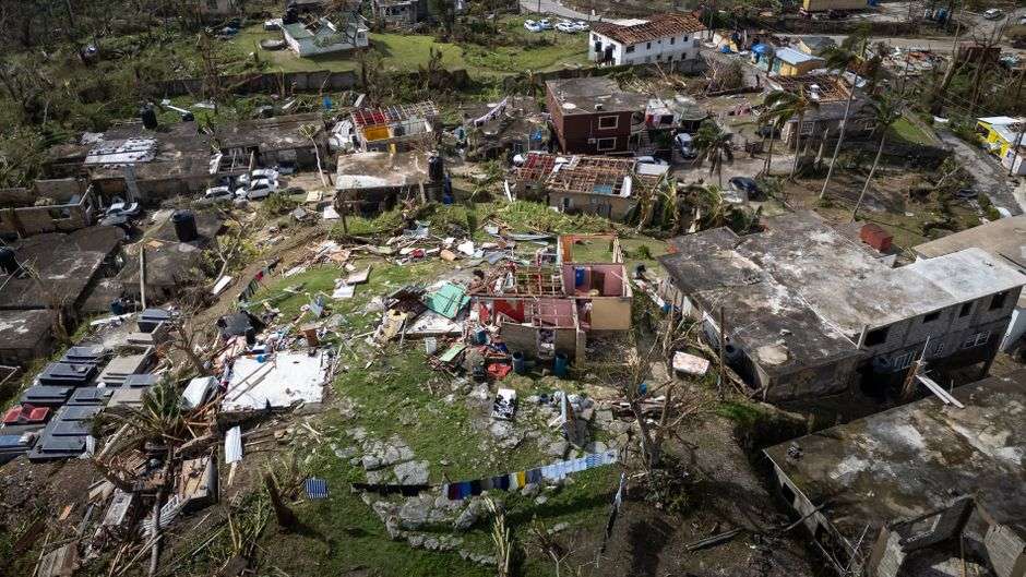 Storm-damaged homes and debris in a coastal Alabama neighborhood following a hurricane