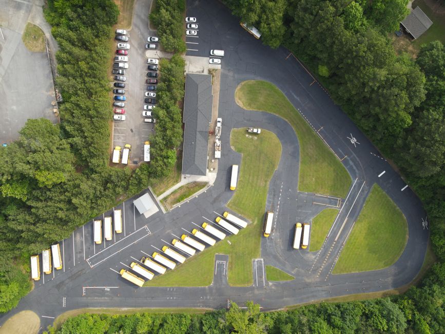 Cars lined up in a school drop-off driveway