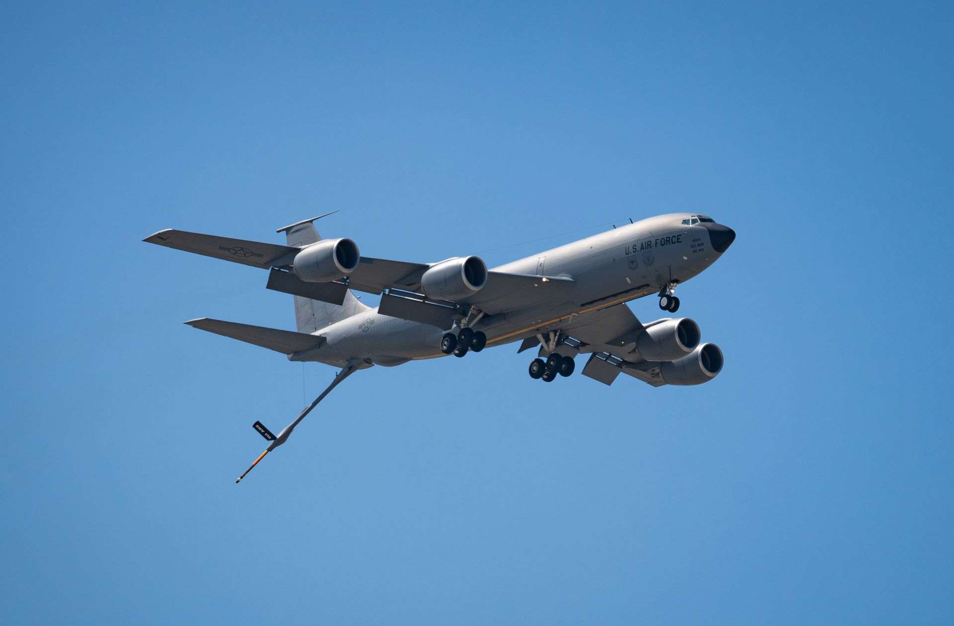 A U.S. Air Force aerial refueling tanker aircraft flying against a clear sky