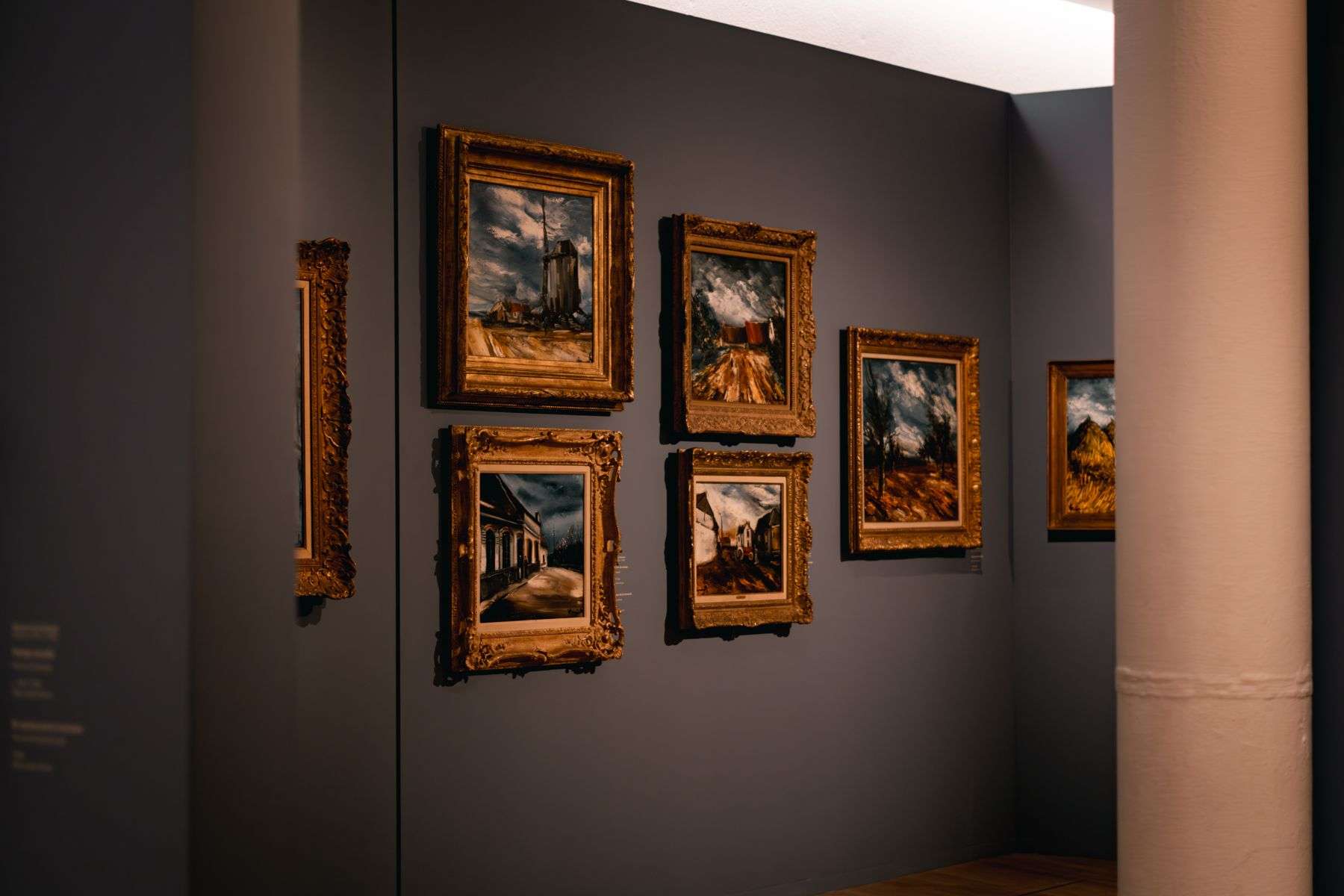 Framed paintings hanging on a gallery wall