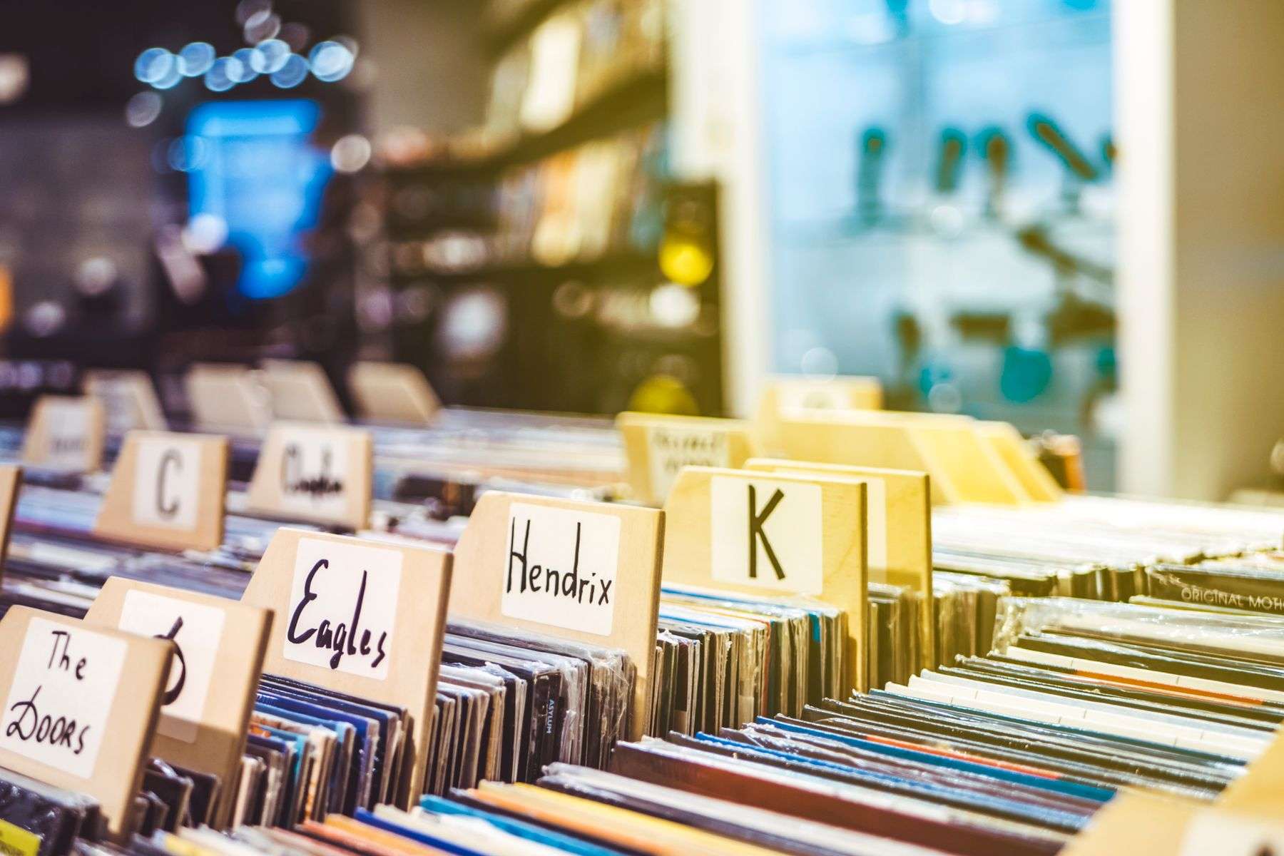 Crates of vinyl records lined up for browsing inside a record store