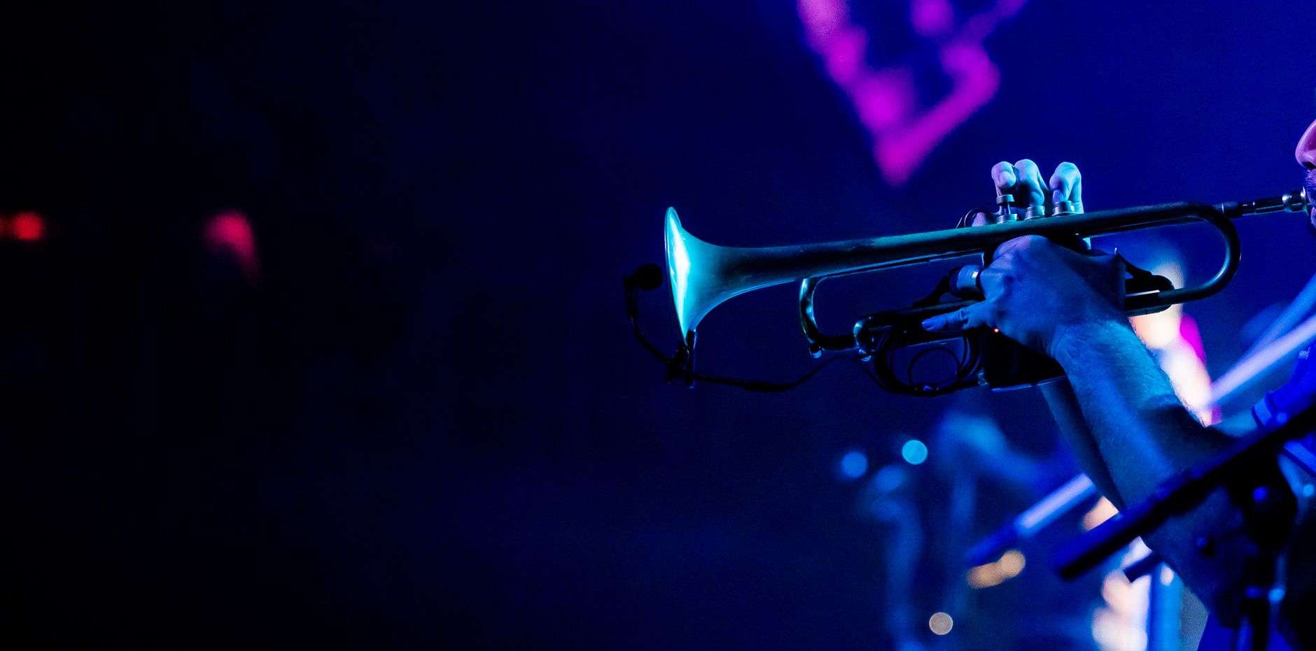 A trumpet player performing on stage during a jazz concert